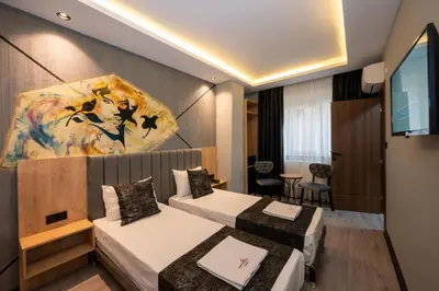 a hotel room with two beds and a flat screen tv at Comfort Point in Istanbul