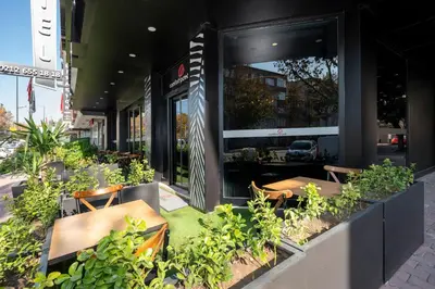 a restaurant with tables and chairs in front of a building at Comfort Point in Istanbul