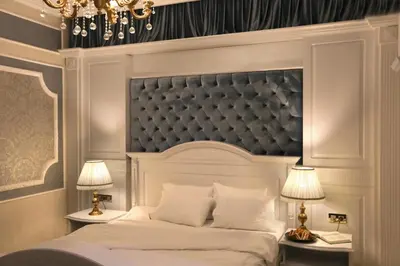 a bedroom with a large white bed with two lamps at Legacy Ottoman Hotel Istanbul Old City in Istanbul