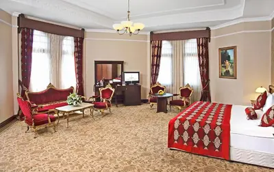 a hotel room with a bed and a living room at Legacy Ottoman Hotel Istanbul Old City in Istanbul