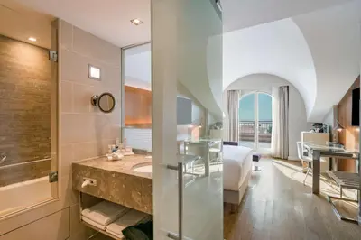 a bathroom with a sink and a bed in a room at Radisson Blu Bosphorus Hotel in Istanbul