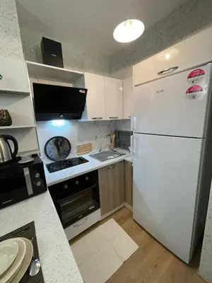 a kitchen with a white refrigerator and a sink at Classic Suite BH13 in Esenyurt