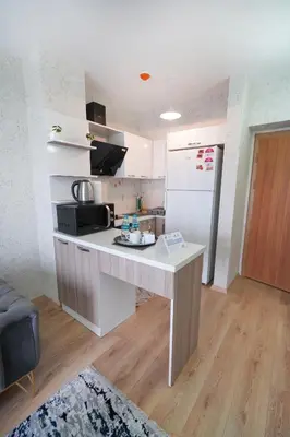 a kitchen with a white counter and a refrigerator at Classic Suite BH13 in Esenyurt
