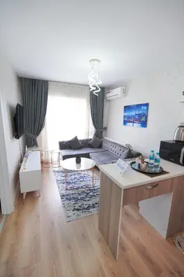 a living room with a couch and a table at Classic Suite BH13 in Esenyurt