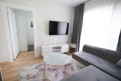a living room with a couch and a table at Classic Suite SH17 in Esenyurt
