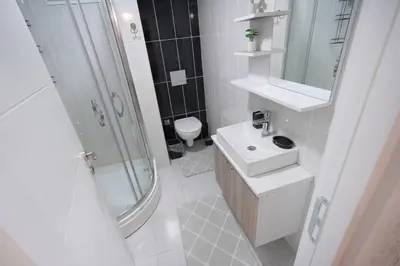 a bathroom with a sink and a shower and a toilet at Classic Suite SH17 in Esenyurt