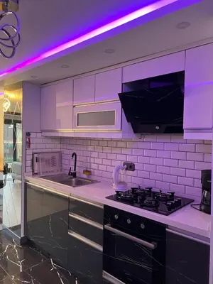a kitchen with a stove and a sink and purple lighting at Ortakoy Suit in Istanbul