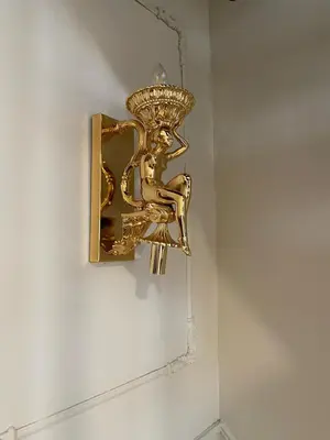 a gold sconce hanging on a wall at Fatih Balat tarihin içinden konut - 3 in Istanbul