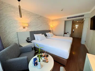a hotel room with a bed and a couch at Dedeman Istanbul in Istanbul