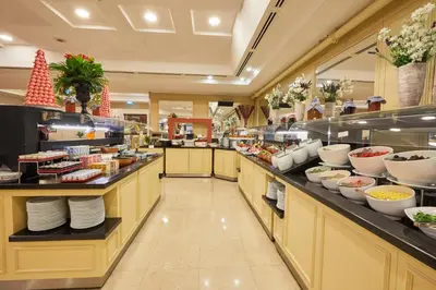 a buffet line in a restaurant with food at Dedeman Istanbul in Istanbul