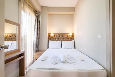 a bedroom with a white bed with a bow on it at Lavin Hotel & Suites in Istanbul