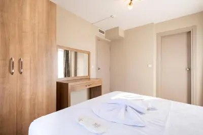 a bedroom with a white bed and a mirror at Lavin Hotel & Suites in Istanbul