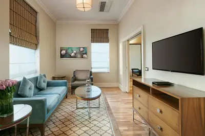 a living room with a couch and a flat screen tv at Titanic Business Kartal in Istanbul