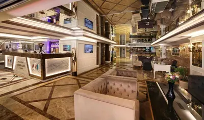 a lobby of a hotel with couches and a bar at Skalion Hotel in Istanbul