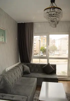 a living room with a couch and a chandelier at Classic Suite AA7 in Esenyurt
