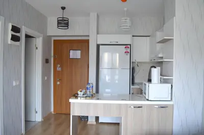 a kitchen with a white refrigerator in a room at Classic Suite AA7 in Esenyurt