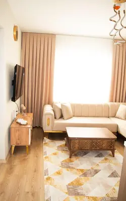 a living room with a couch and a coffee table at Two Bedroom King Suite TH30 in Esenyurt