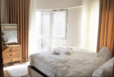 a bedroom with a bed with two towels on it at Two Bedroom King Suite TH30 in Esenyurt