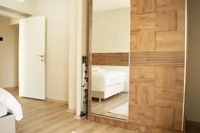 a sliding door with a mirror in a bedroom at Two Bedroom King Suite TH30 in Esenyurt