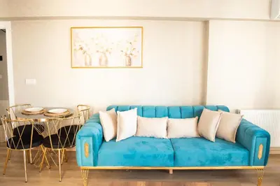 a blue couch in a living room with a table at King Suite AN33 in Esenyurt