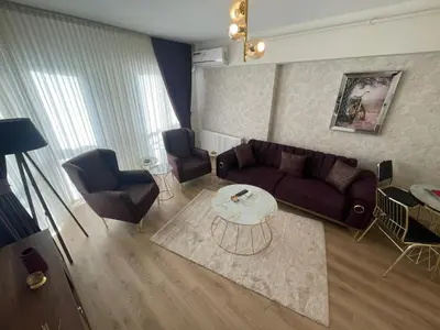 a living room with a couch and a table at King Suite SS2 in Esenyurt