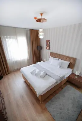 a bedroom with a large bed with two towels on it at King Suite SS2 in Esenyurt