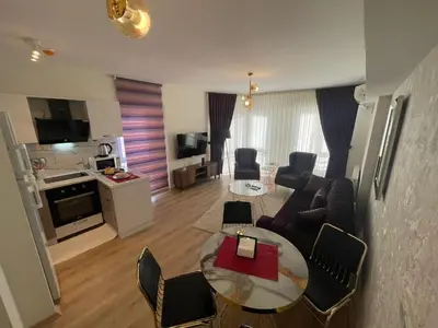 a living room with a couch and a table at King Suite SS2 in Esenyurt