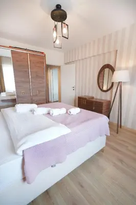 a bedroom with a large bed with a pink blanket at King Suite MS5 in Esenyurt