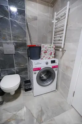 a washing machine in a bathroom with a toilet at King Suite MS5 in Esenyurt
