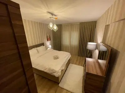 a small room with a bed and a table and a lamp at King Suite TC1 in Esenyurt
