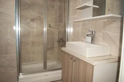 a bathroom with a sink and a shower at King Suite TC1 in Esenyurt