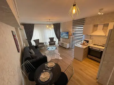 a living room with a couch and a table at King Suite TC1 in Esenyurt