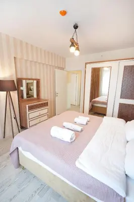 a bedroom with a large bed and a mirror at King Suite AM2 in Esenyurt