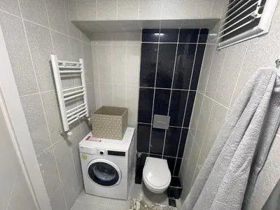 a bathroom with a washing machine and a toilet at King Suite AM2 in Esenyurt