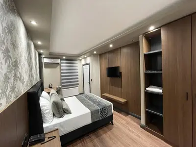 a bedroom with a bed and a flat screen tv at GRAND ÜSKÜDAR OTEL in Istanbul