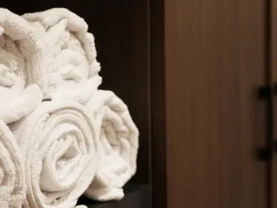a pile of white towels sitting on a shelf at GRAND ÜSKÜDAR OTEL in Istanbul