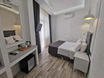 a hotel room with a bed and a mirror at Efzen hotel in Istanbul
