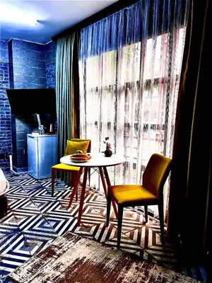 a living room with a table and two chairs at Mates Port Hotel in Istanbul