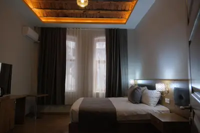 a hotel room with a bed and a window at Adamantides Hotel in Istanbul