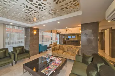 a living room with couches and a table at Bisetun Hotel in Istanbul