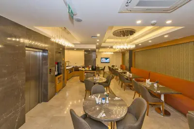 a restaurant with tables and chairs and a bar at Bisetun Hotel in Istanbul