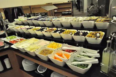a buffet line with many trays of food at Bisetun Hotel in Istanbul