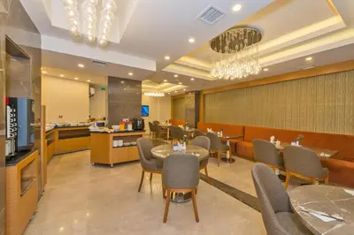 a restaurant with tables and chairs and a bar at Bisetun Hotel in Istanbul