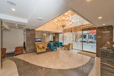 a lobby of a building with a chandelier at Bisetun Hotel in Istanbul