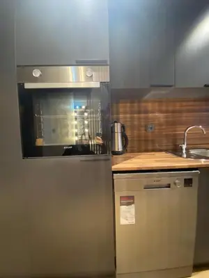 a kitchen with a stainless steel refrigerator and a sink at BlokNoi in Istanbul