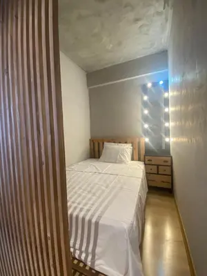 a small bedroom with a white bed and a dresser at BlokNoi in Istanbul