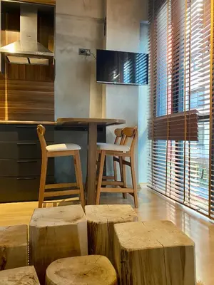 a kitchen with a table and some wooden stools at BlokNoi in Istanbul