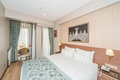 a hotel room with a bed and a window at Taximist Hotel in Istanbul