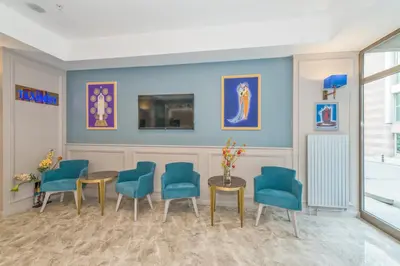 a waiting room with blue chairs and a table at Taximist Hotel in Istanbul