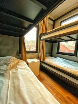 a bedroom with two bunk beds and a window at Nomad Hostel Karaköy in Istanbul
